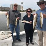 Angler battling a trophy redfish on a 6-hour inshore charter off Pensacola Beach with Showintail Inshore Charters