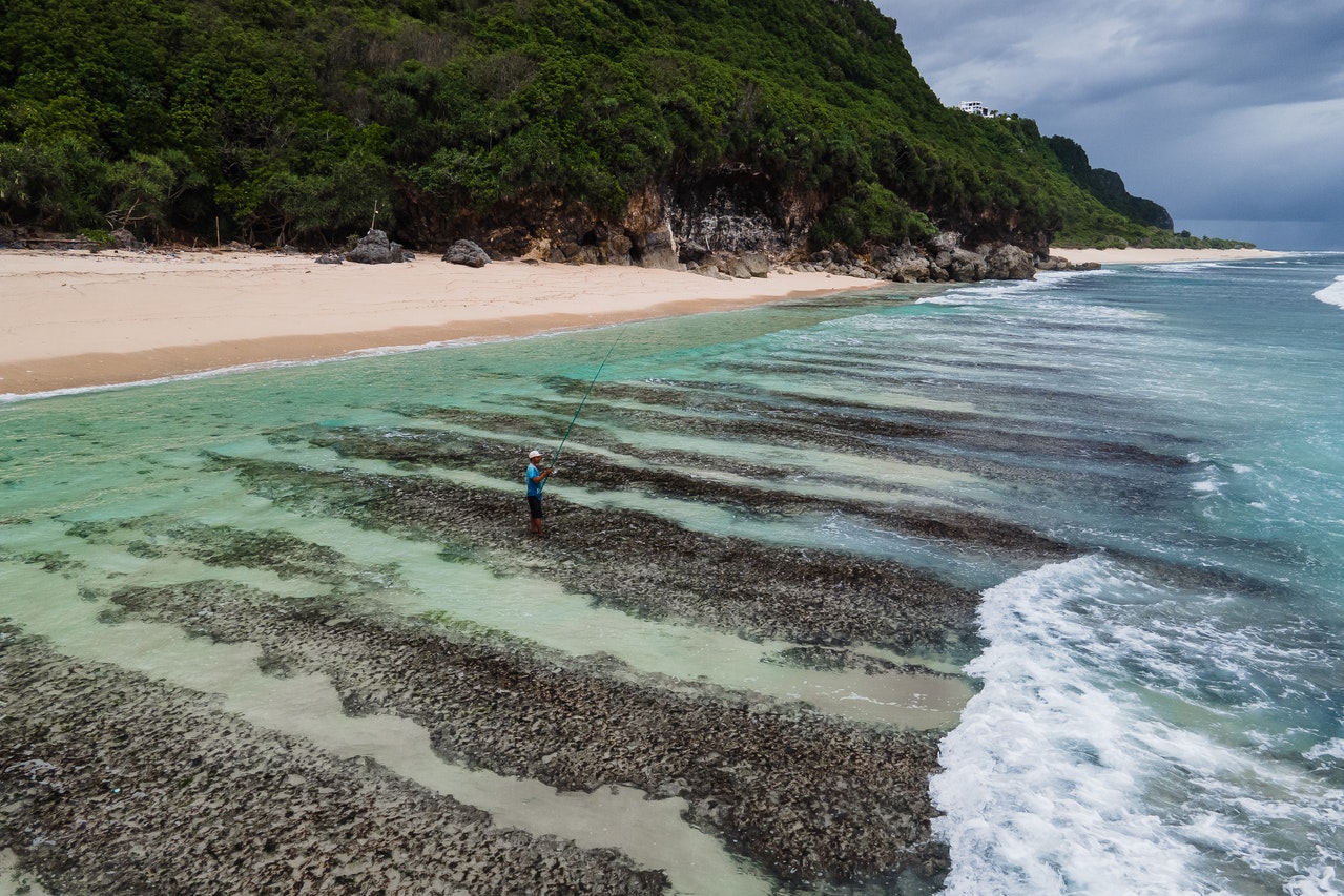 man fishing at the beach