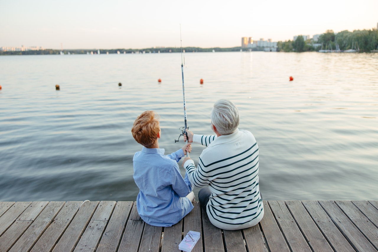 father and son fishing on the dock