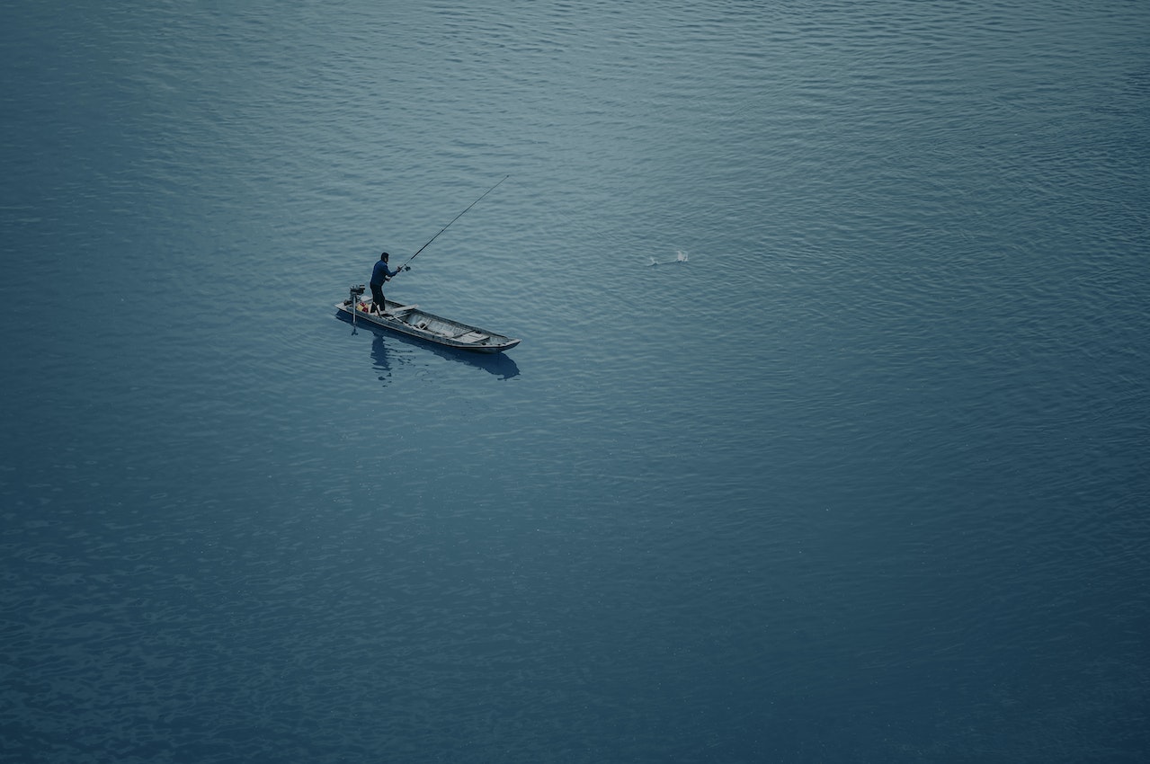 man on boat fishing