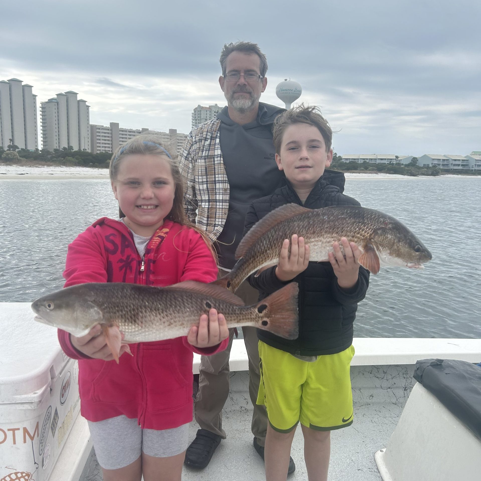 Young angler reeling in a redfish on a Kids Fishing Charter with Showintail Inshore Charters in Navarre Beach, Florida