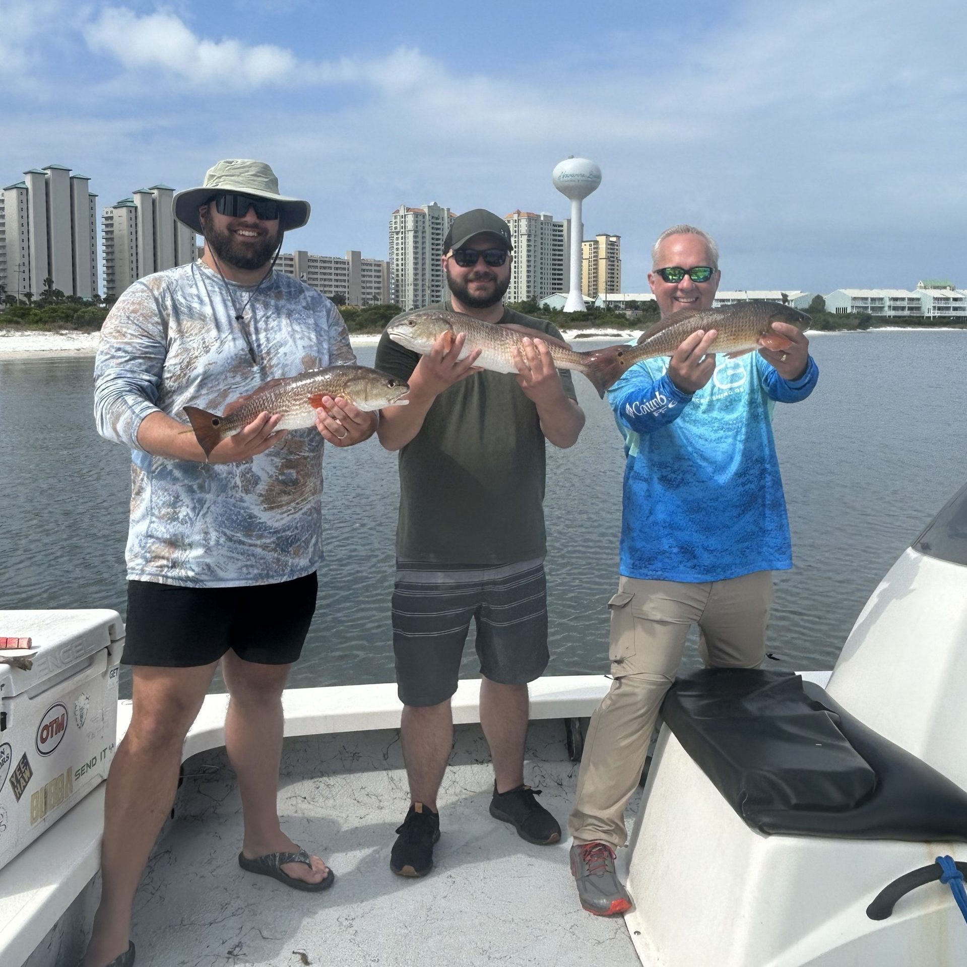Family smiling with Redfish on a 3-hour family fishing charter with Showintail Inshore Charters in Navarre Beach, Florida