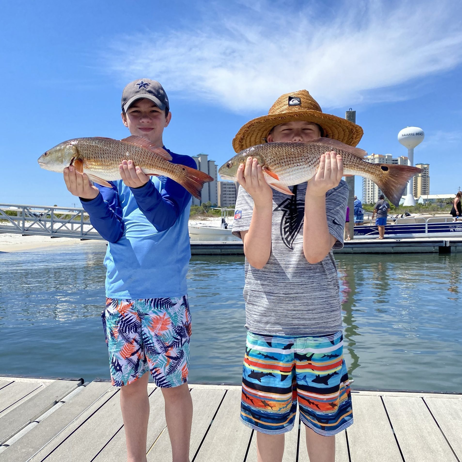 A child holding a fish on a family-friendly inshore fishing trip in Fort Walton Beach, Florida.