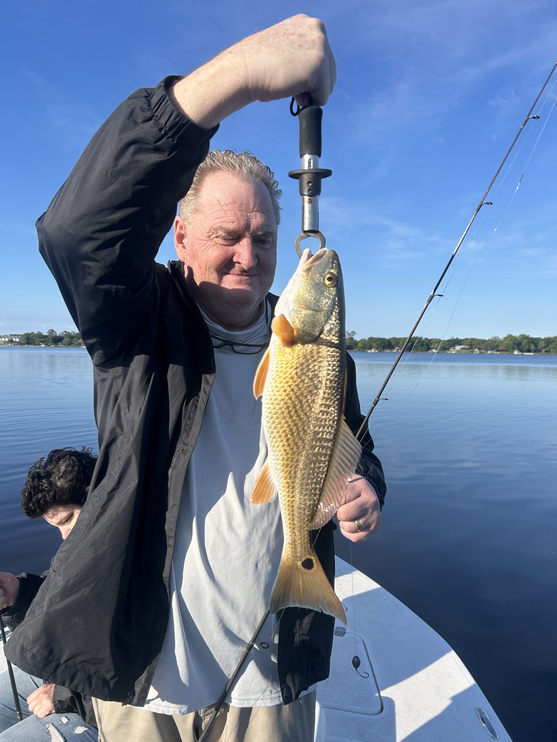 Captain guiding young angler during an inshore fishing charter with Showintail Inshore Charters in Florida