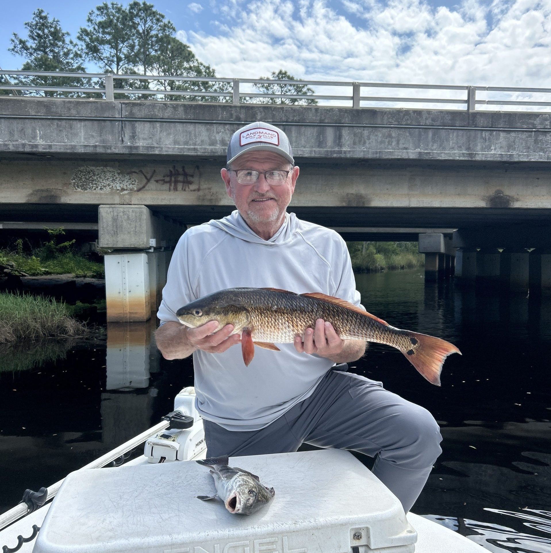Family holding Redfish on a Fort Walton Beach fishing charter with Showintail Inshore Charters