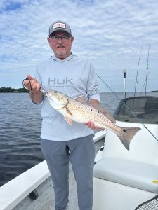 Anglers holding Redfish during a Destin fishing charter with Showintail Inshore Charters in Destin, Florida