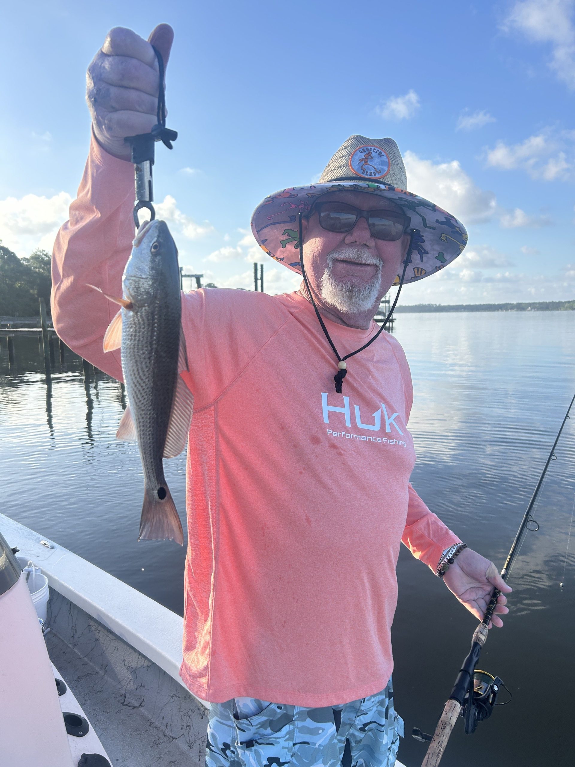 angler holding redfish caught on morning charter in navarre beach