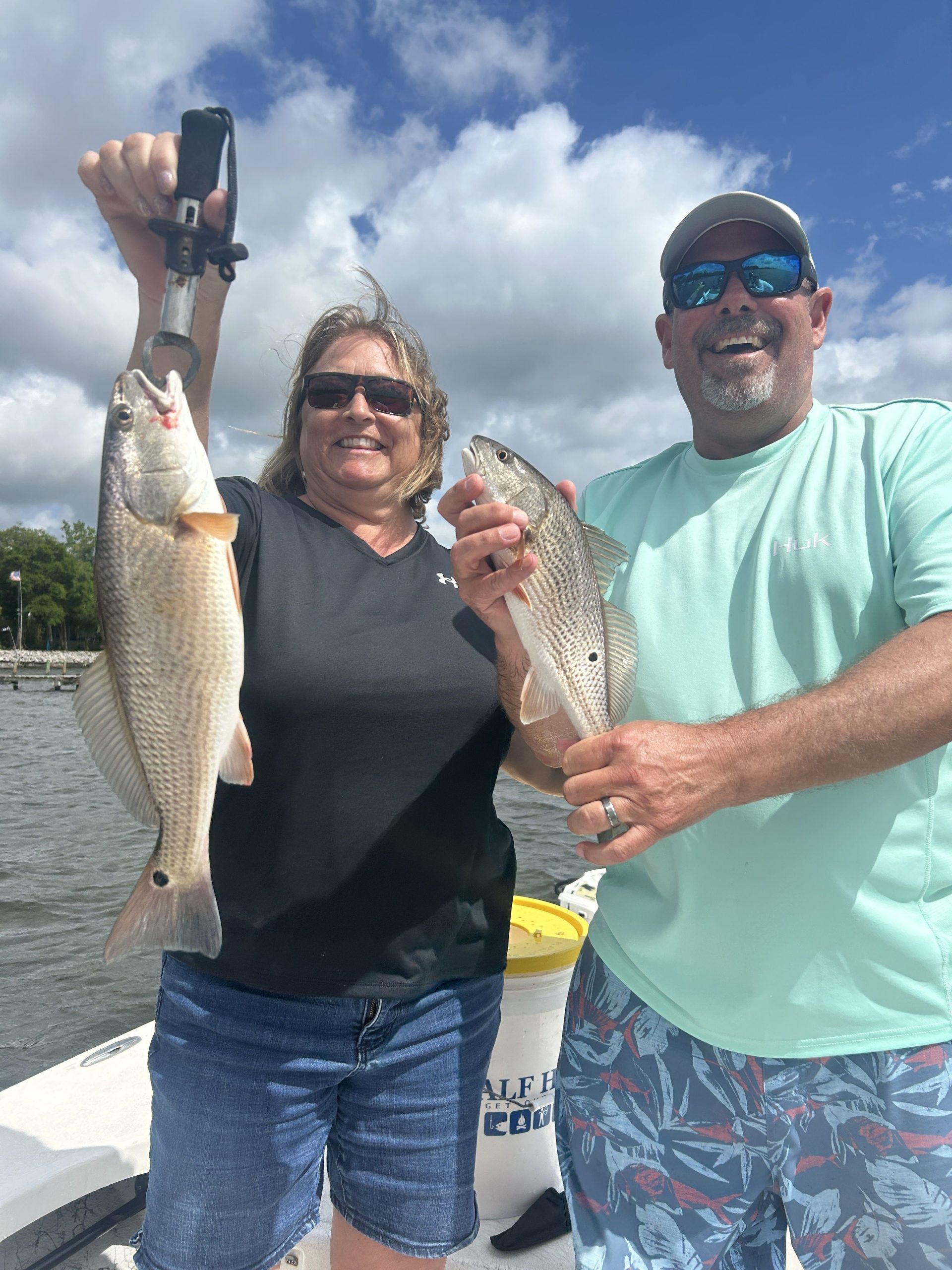Angler holding a big redfish caught on Navarre Beach fishing charter