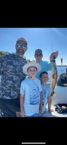 angler holding redfish caught on Navarre Beach inshore fishing charter