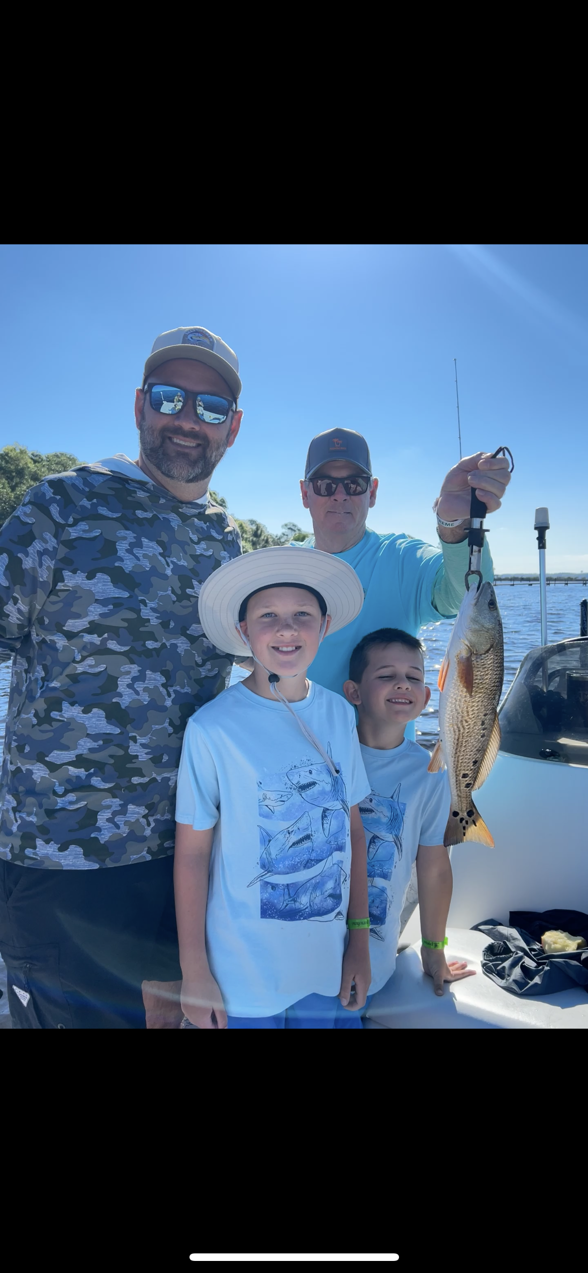 angler holding redfish caught on Navarre Beach inshore fishing charter