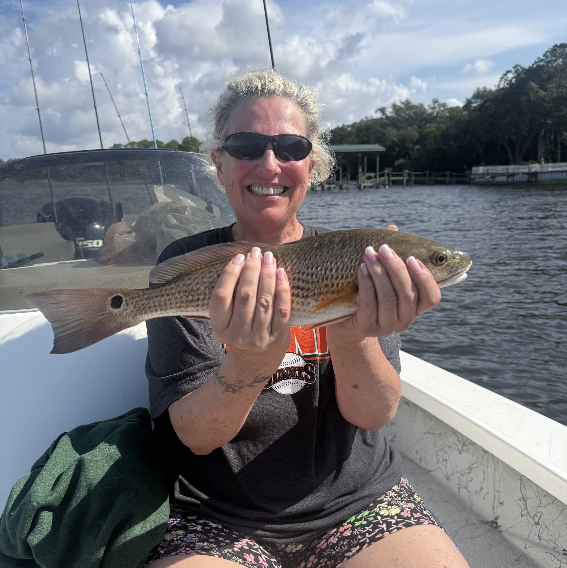 Family fishing on a calm morning in Navarre, Florida catching redfish with Showintail Inshore Charters