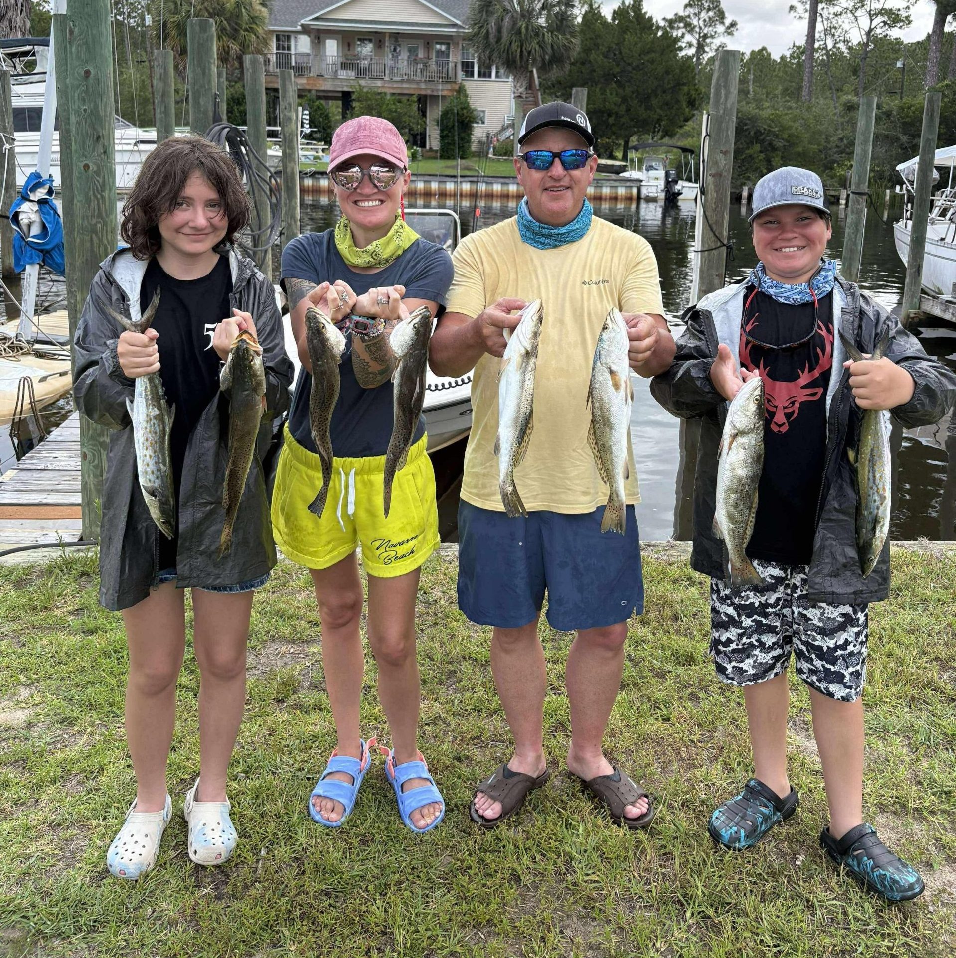 Couple holding redfish during a guided fishing charter in Miramar Beach, Florida