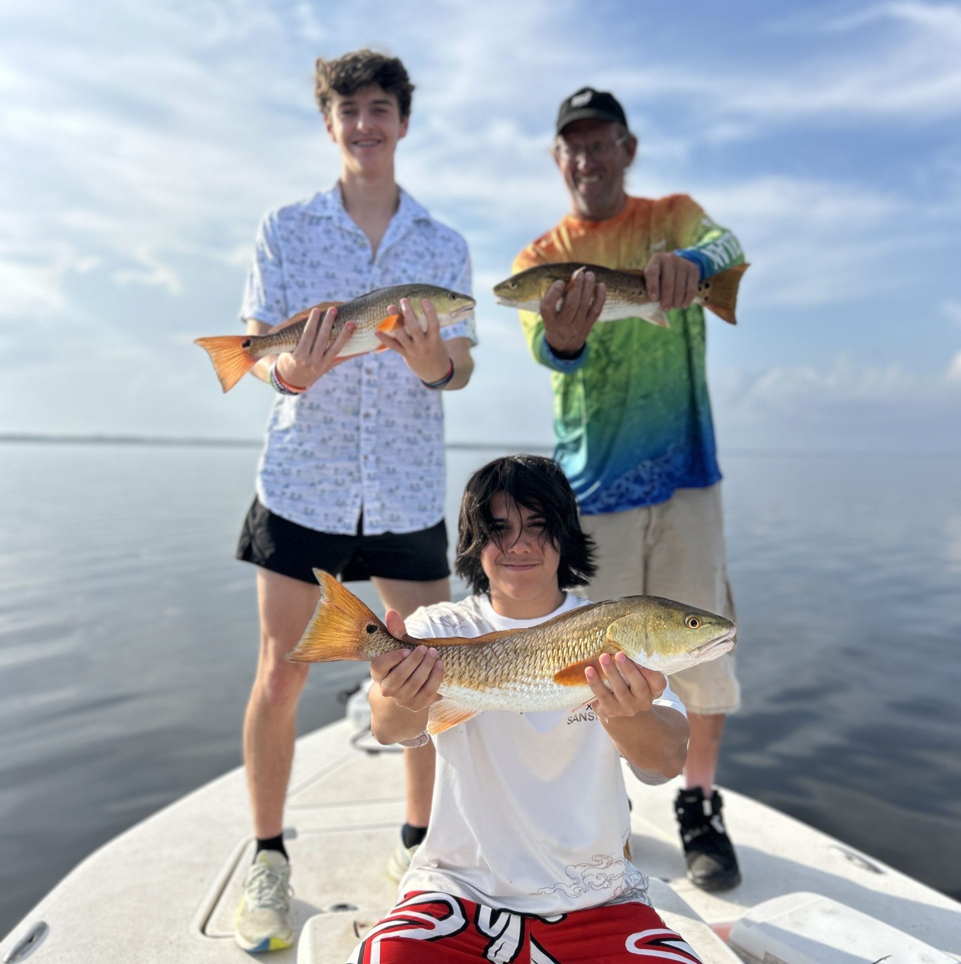 4-hour half-day inshore fishing charter in Navarre Beach Florida with angler holding a redfish in Santa Rosa Sound
