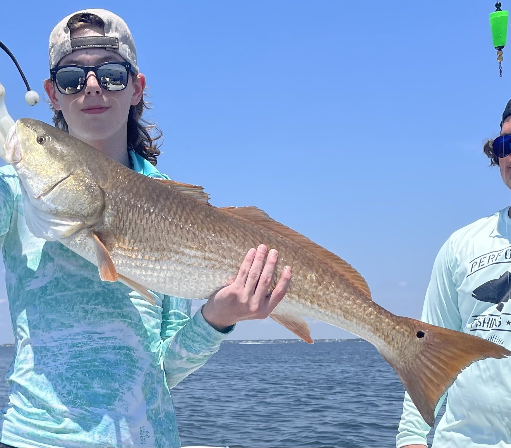 6-hour fishing charter in Navarre Beach FL with anglers holding multiple fish from an extended inshore trip